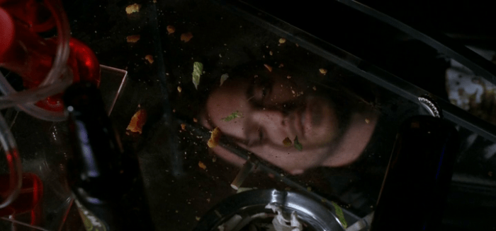 Aaron Paul under a coffee table in Breaking Bad Season 5 Episode 9 - "Blood Money"